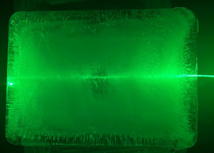 Trippy Wire frozen inside a block of ice, still glowing green.